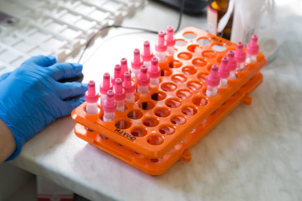 Various test tubes in an orange rack inside a laboratory setting.